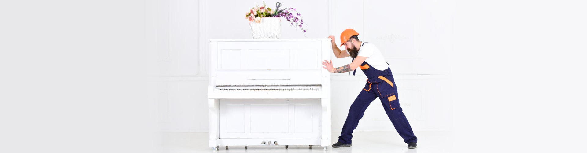 male movers pushing the piano